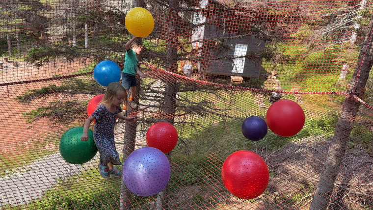 Giant suspended trampoline in the trees at Folies Boréales, Percé